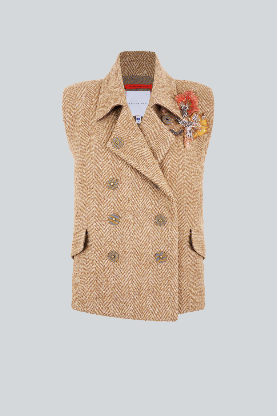 Chaleco Stardust oversized de lana Spiga en camel e ivory, con apliques florales bordados a mano. Una pieza sofisticada para el guardarropa.